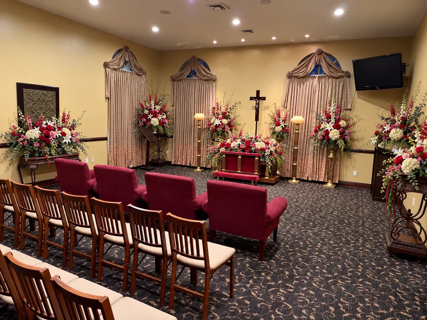 Chapel seating and floral arrangements prepared for a gathering