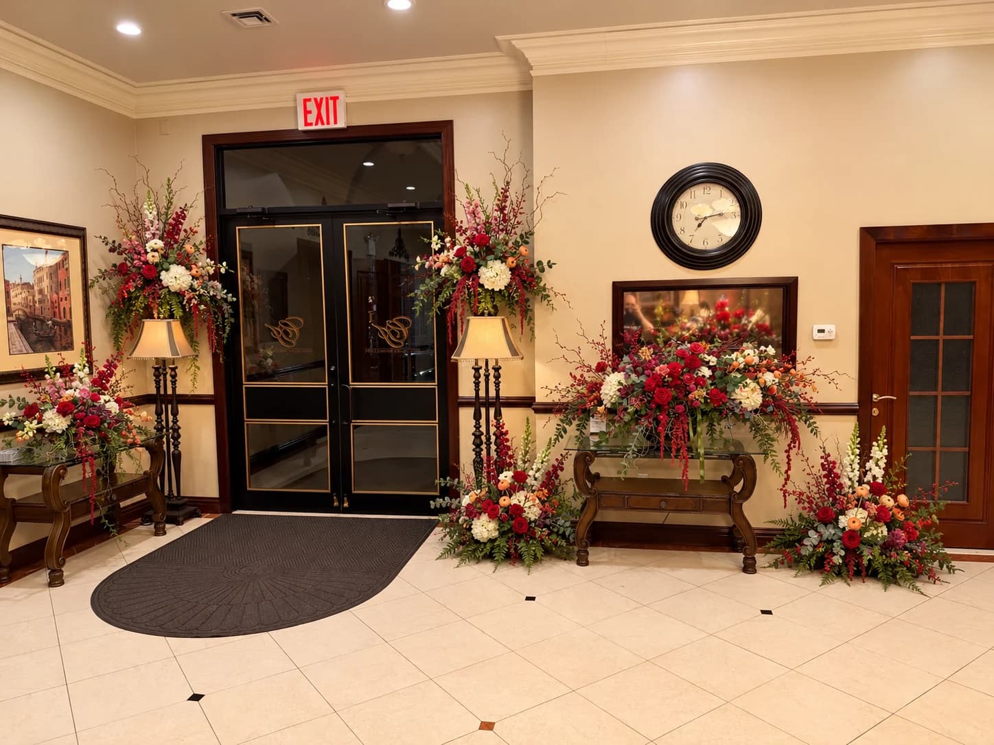 The funeral home's entrance lobby with glass doors and floral arrangements